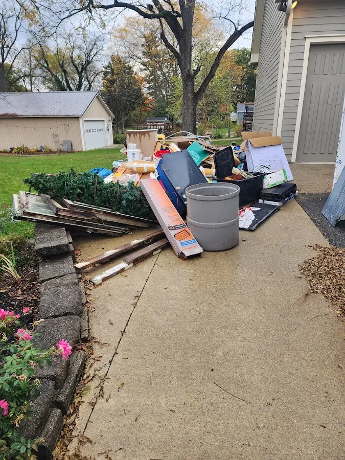 Dumpster being loaded with debris for 30 Yard Dumpster Rental in Farmington